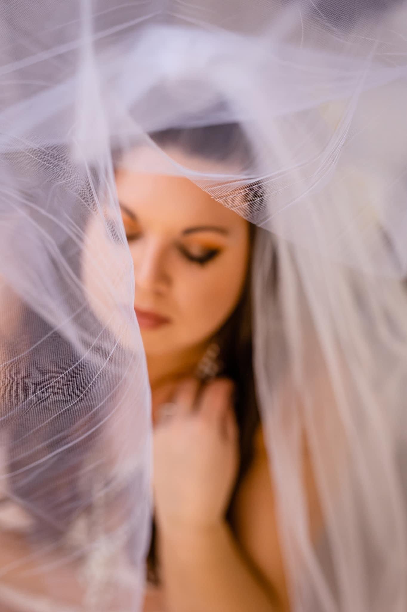 A bride with her veil covering her face.