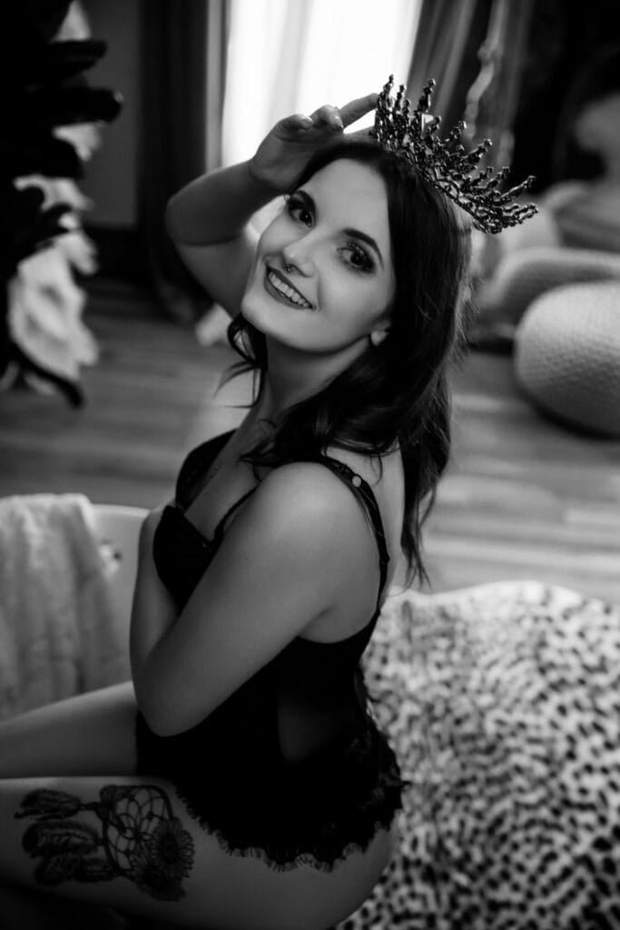 A woman's black and white photo wearing a crown for a photoshoot.