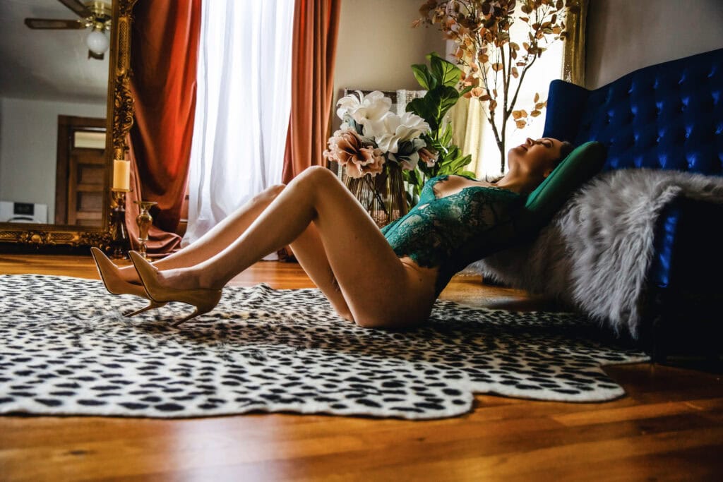 A woman laying on a leopard print rug.